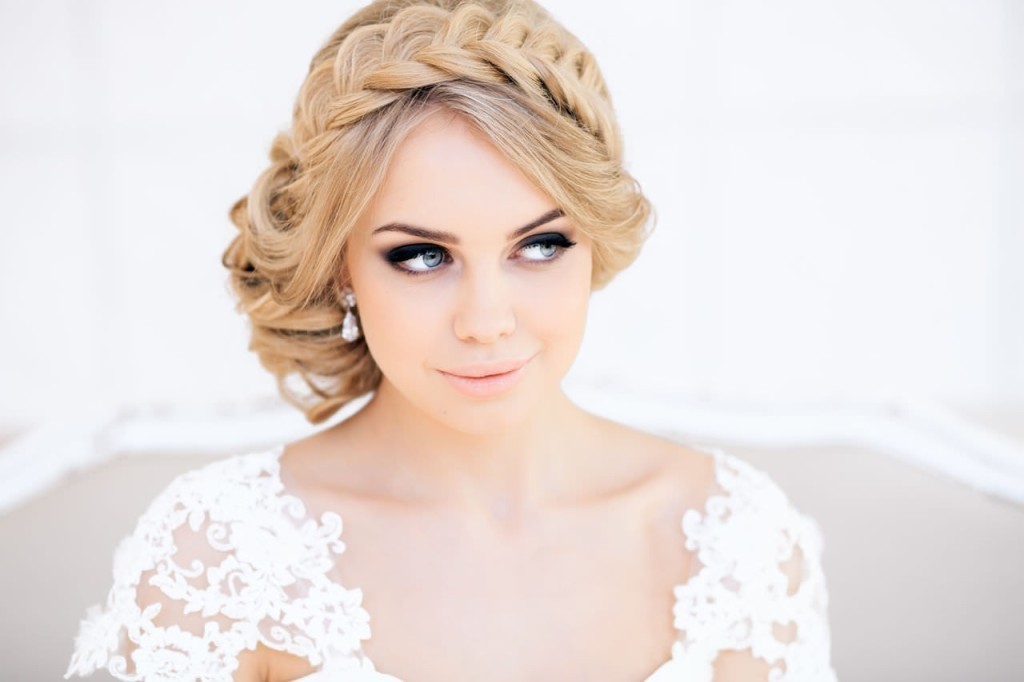 A blond bride with the braid looks to the side