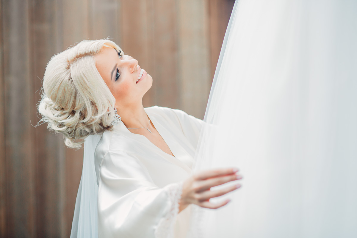 A blond bride smiling up at the sky