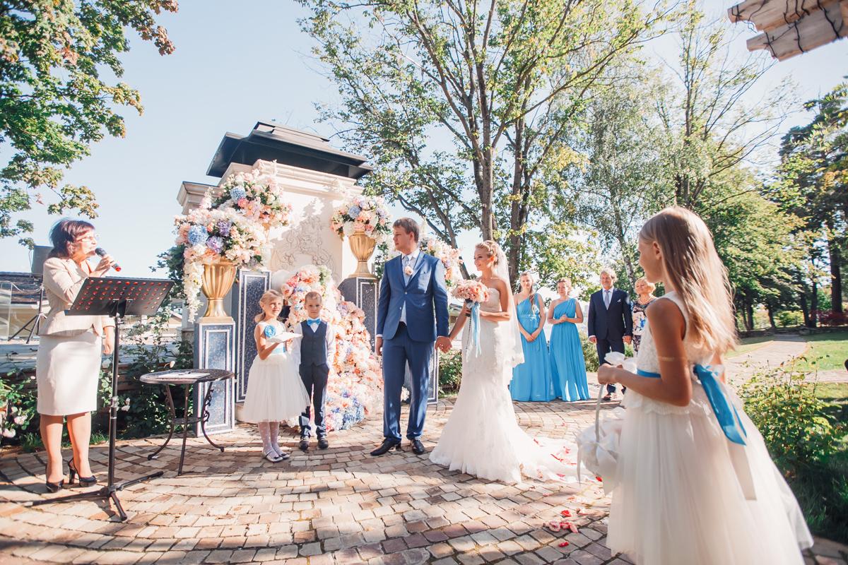 A happy bride stands with the groom